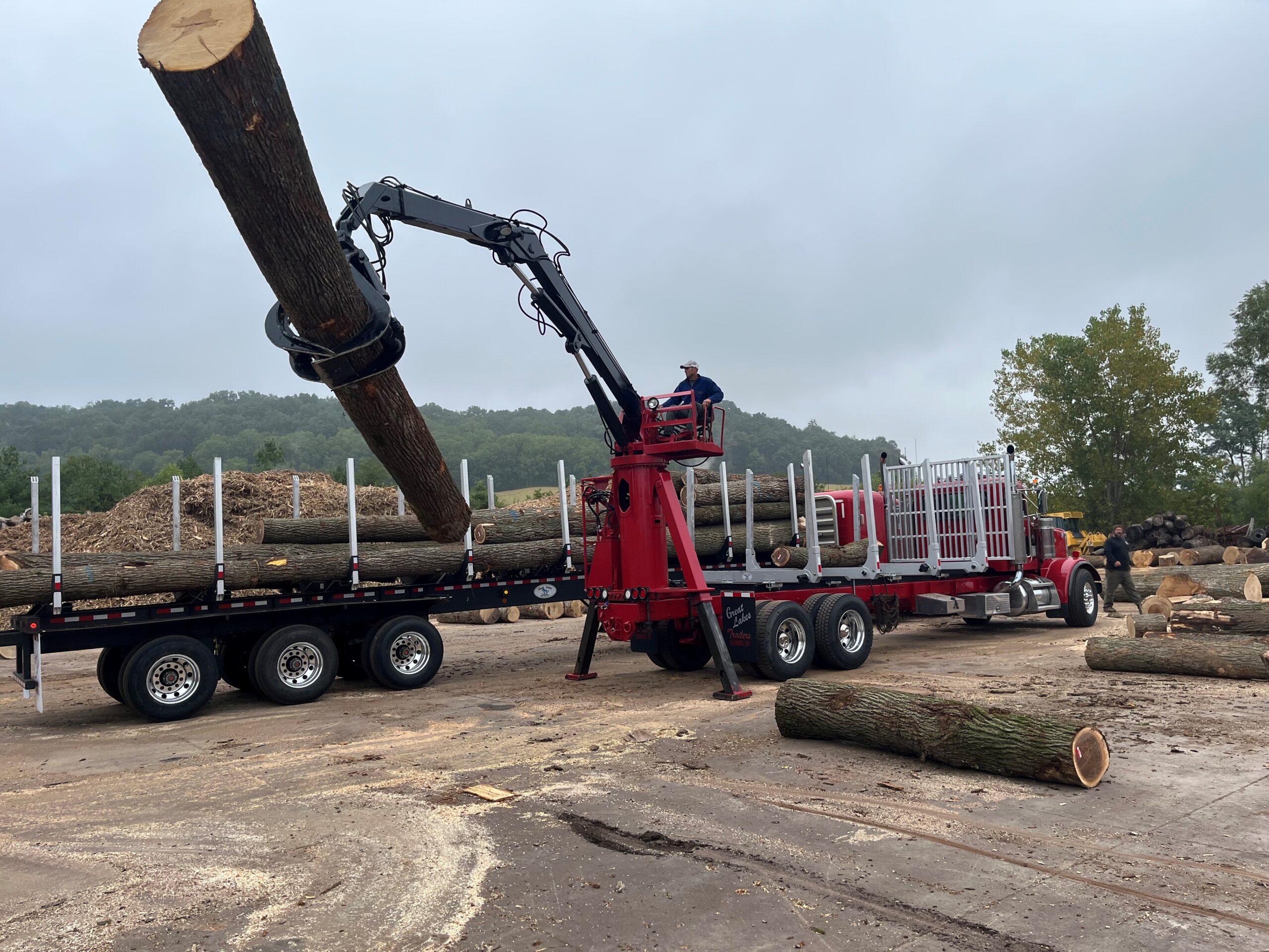 Crane loading a log onto the trailer